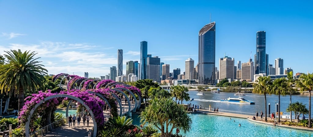 South Bank Parklands in Brisbane with the Streets Beach lagoon, palm trees and city skyline on a sunny winter day